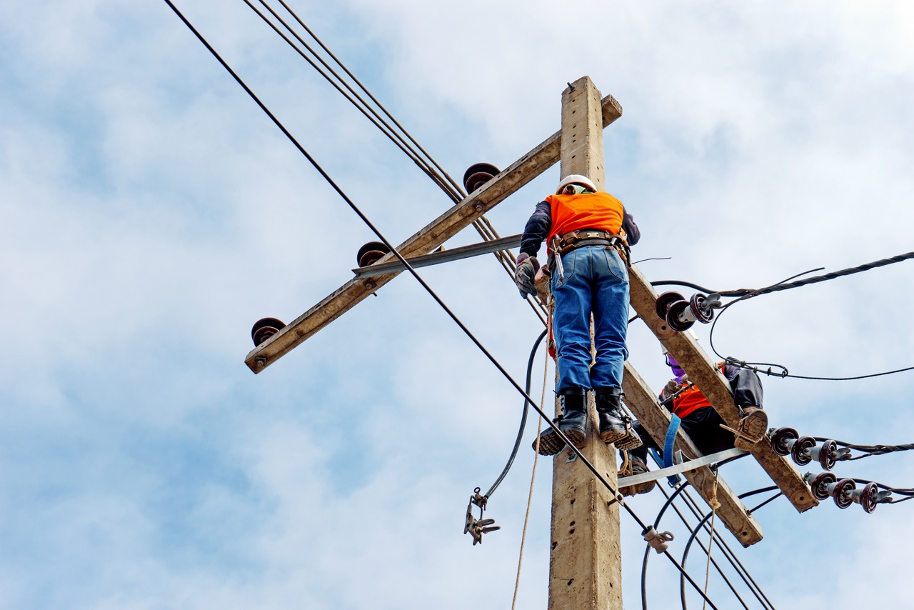 Electrician,Lineman,Repairman,Worker,At,Climbing,Work,On,Electric,Post